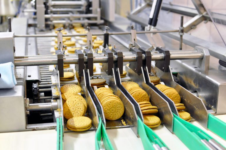Cookies being prepared on a conveyor belt.