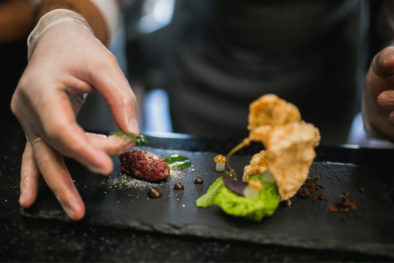 A dish being plated at a molecular gastronomy restaurant.