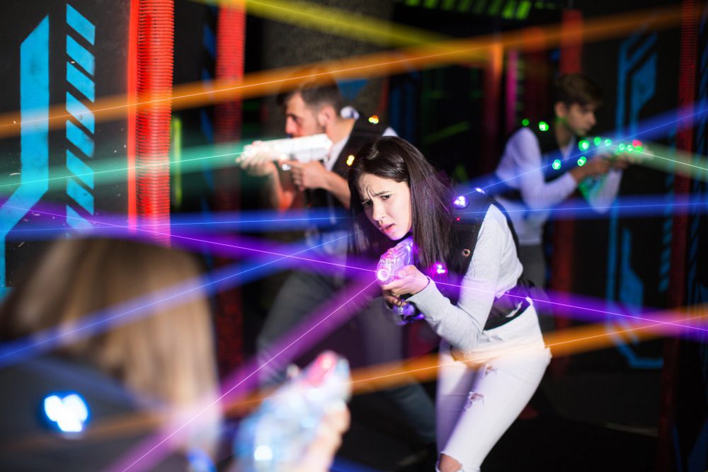 A woman playing a game of laser tag