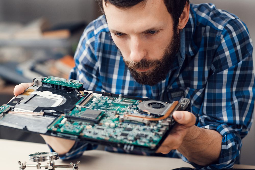 A man inspects a motherboard