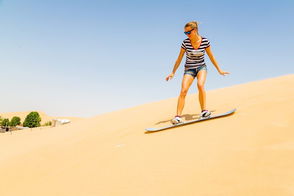 Lone woman sandboarding