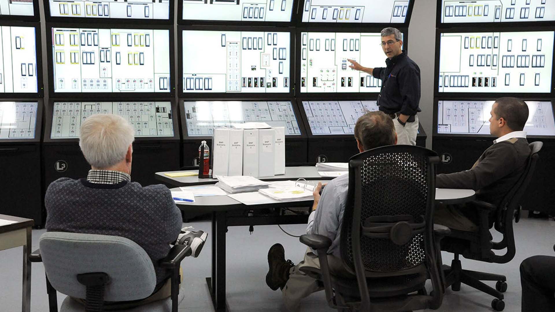 Nuclear energy experts reviewing control room technology safety upgrades; Photo Credit: Idaho National Laboratory