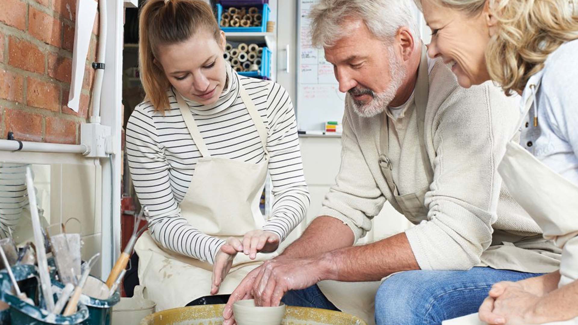 An older couple trying pottery.