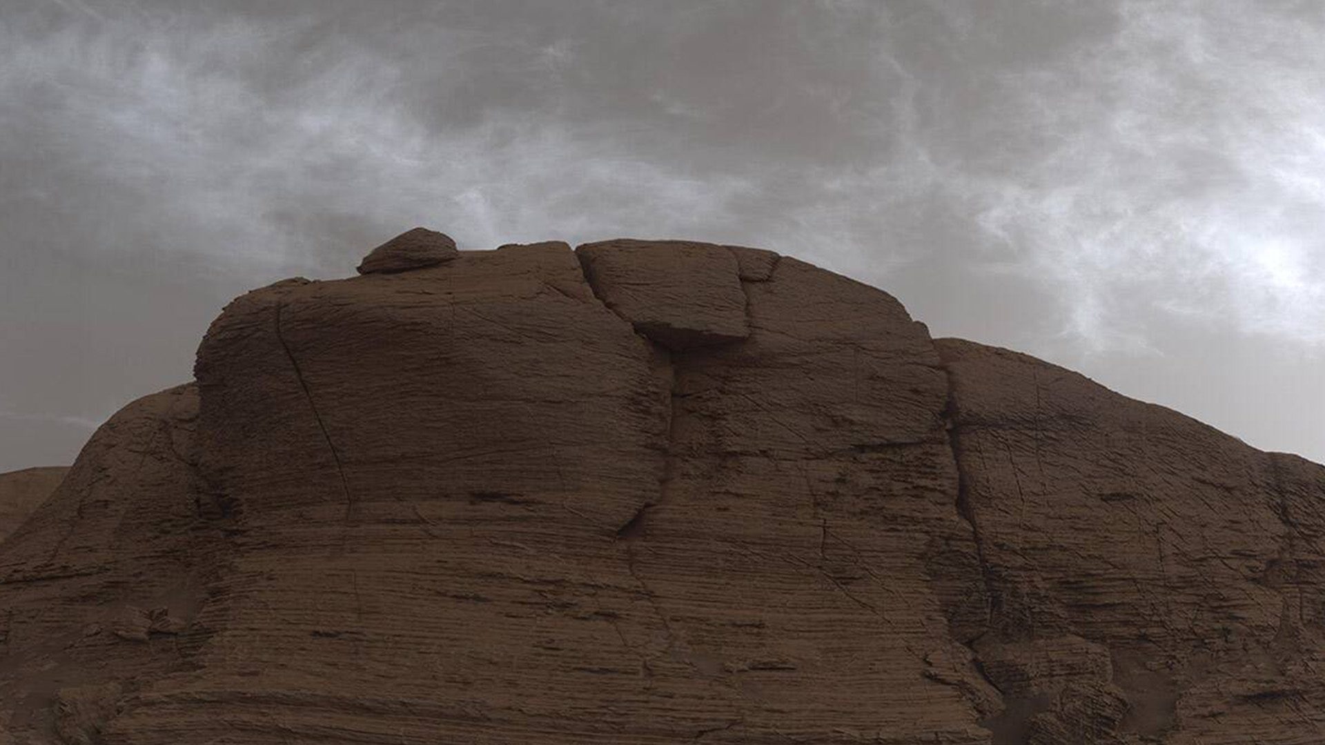 Clouds on Mars as captured by NASA’s Curiosity Mars rover in March 2021. The image is made up of 21 individual images color-corrected and stitched together; Photo Credit: NASA