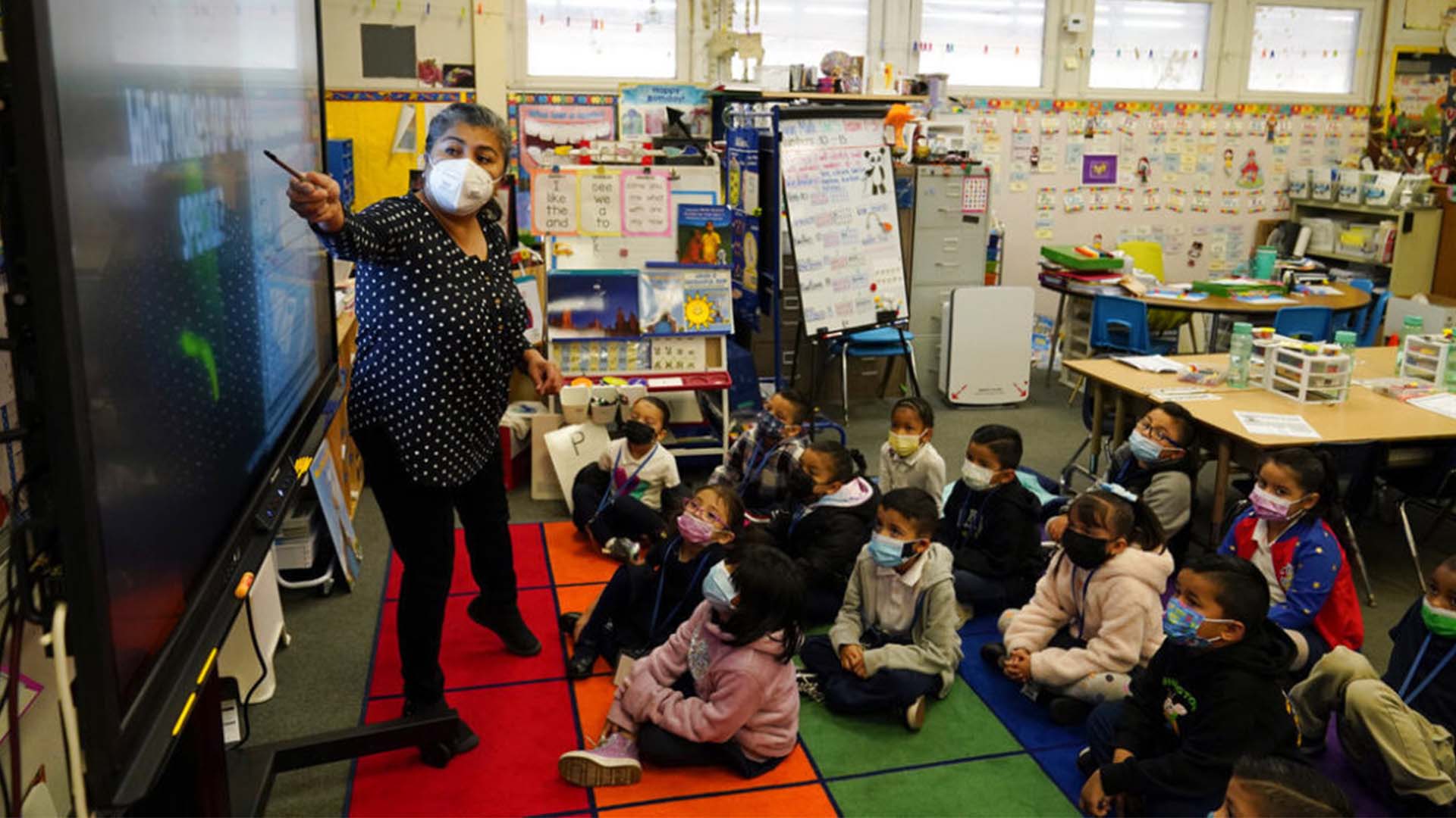 Kindergarten teacher Ana Zavala, at left, instructs students in January 2022 in California; Photo Credit: AP Photo/Marcio Jose Sanchez