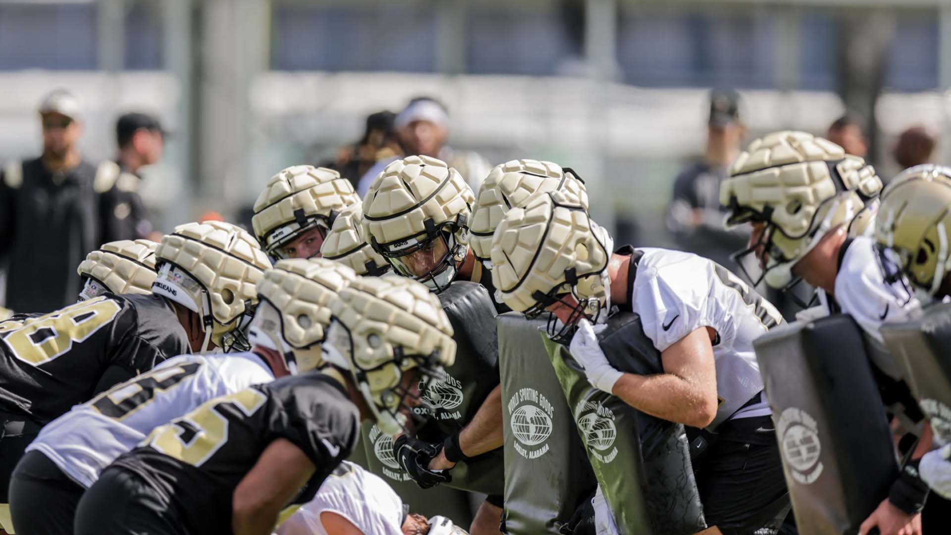 New Orleans Saints linemen in Guardian Caps at training camp