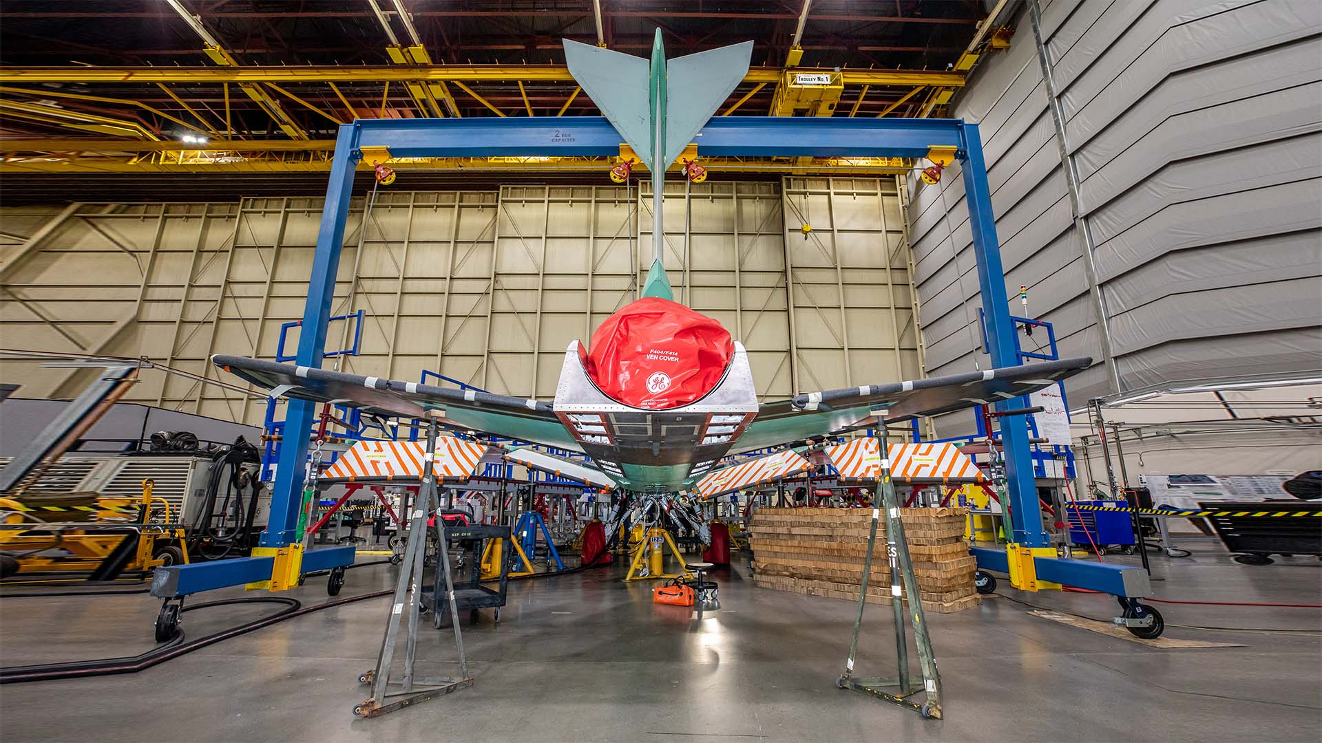 NASA’s X-59 sits in support framing while undergoing the installation of its lower empennage, or tail section, at Lockheed Martin Skunk Works in Palmdale, California