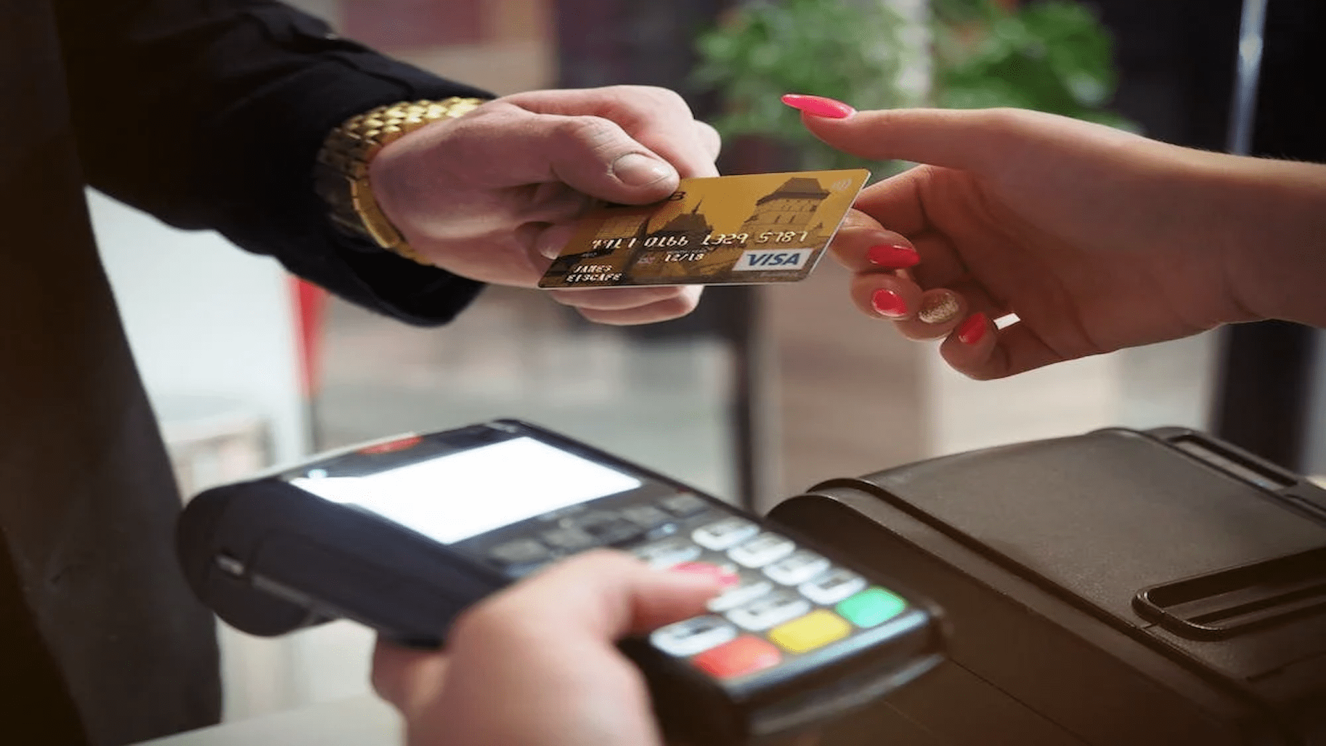 Businessman handing credit card to saleswoman