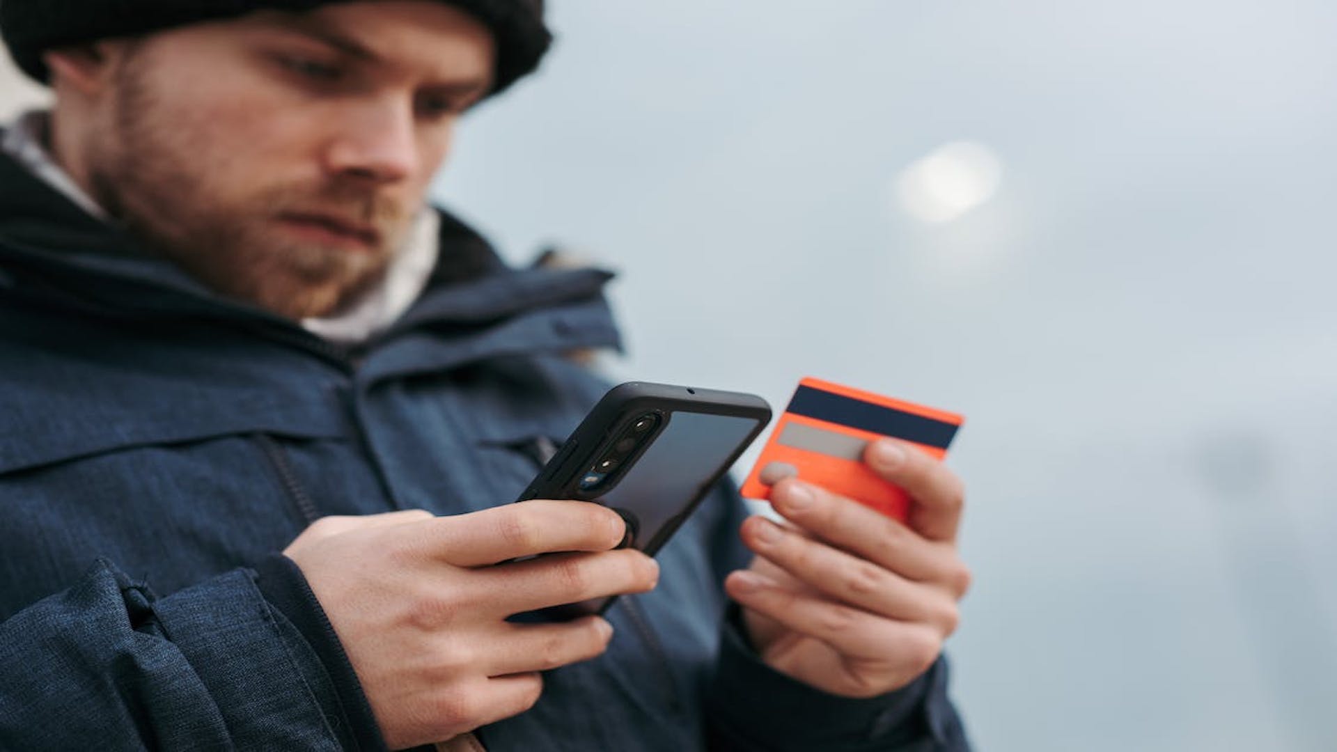 Man comparing credit cards