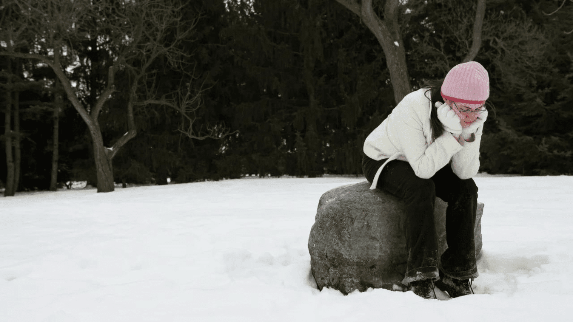 Woman looking sad in the winter snow
