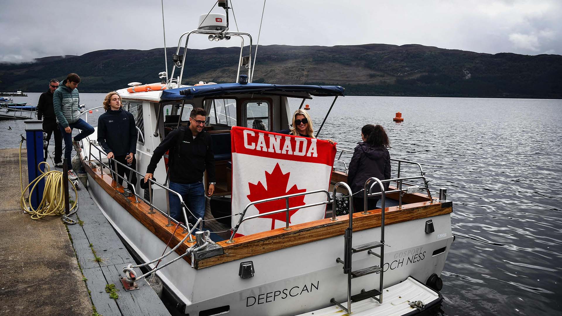 A Canadian flag is held as Loch Ness Research Project vessel 'Deepscan' REUTERS:Russell Cheyne