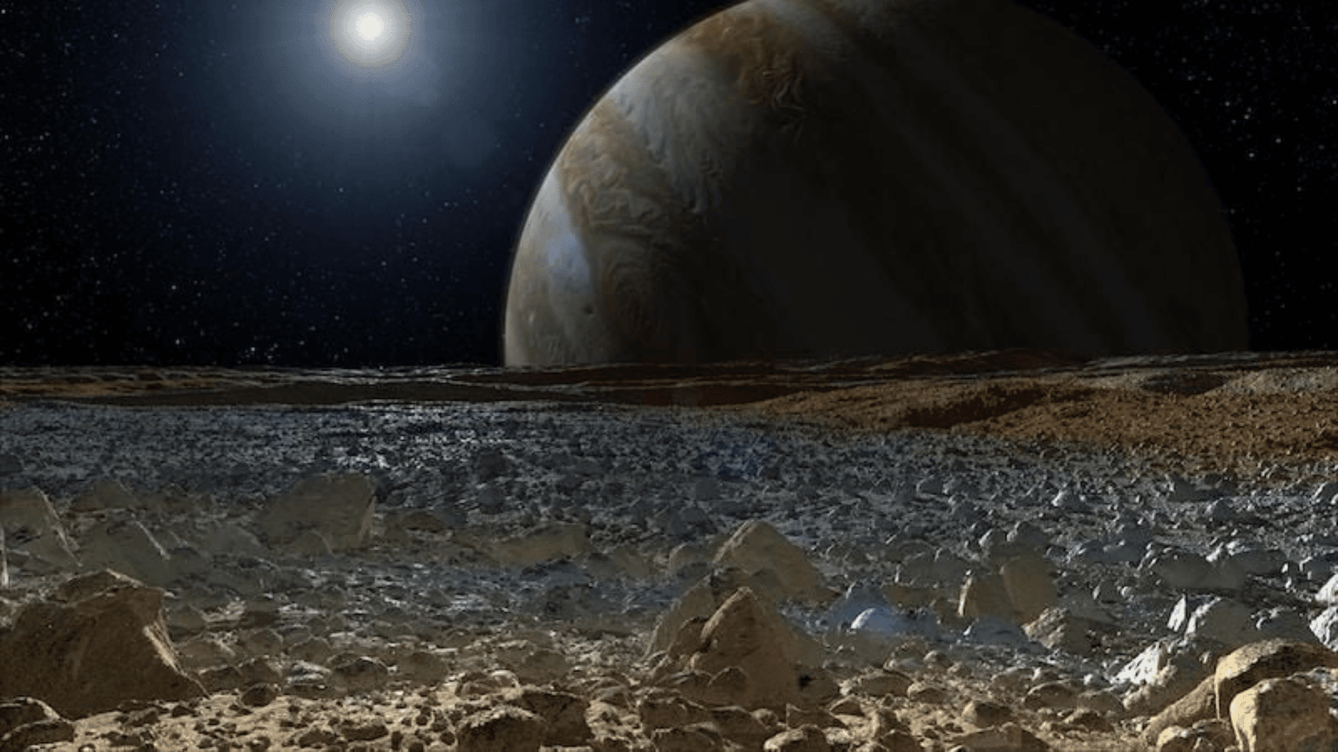 An artist's concept of a simulated view from the rough, icy surface of the moon Europa with Jupiter looming over the horizon. NASA : JPL-Caltech
