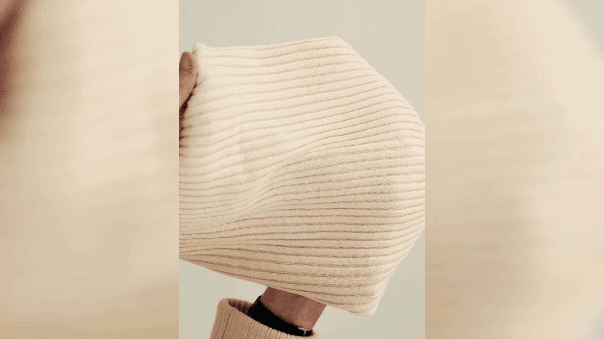 Person holding clothes made with Kelsun fibre Person holding clothes made with Kelsun fibre