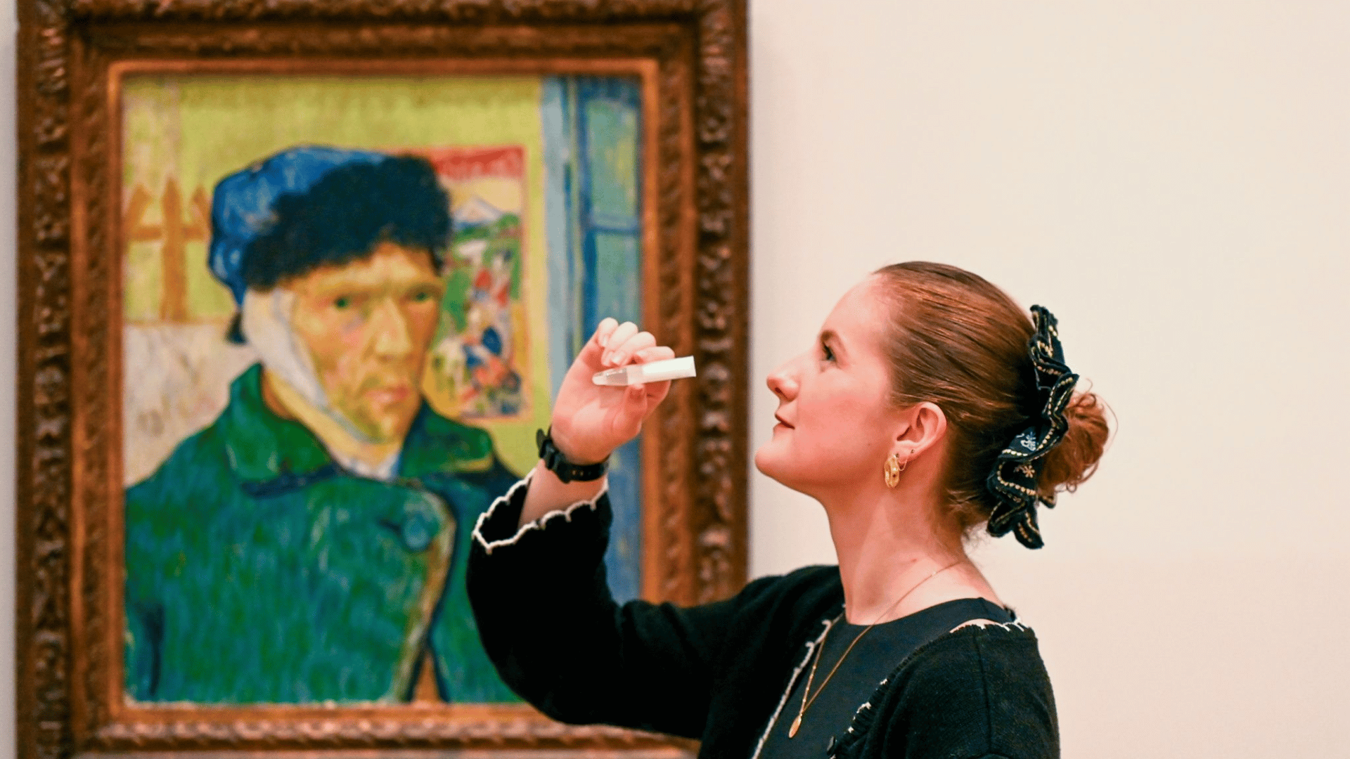 A study participant provides a saliva sample in front of Vincent van Gogh’s Self-Portrait with Bandaged Ear (1889)
