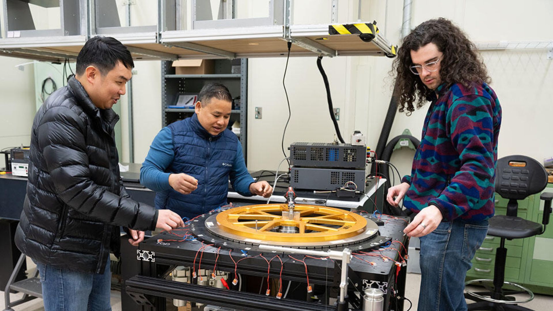 From left NIST researchers Leon Chao, Chandra Shahi and Zane Comden work on the prototype ENTR device on NIST’s campus in Gaithersburg, Maryland